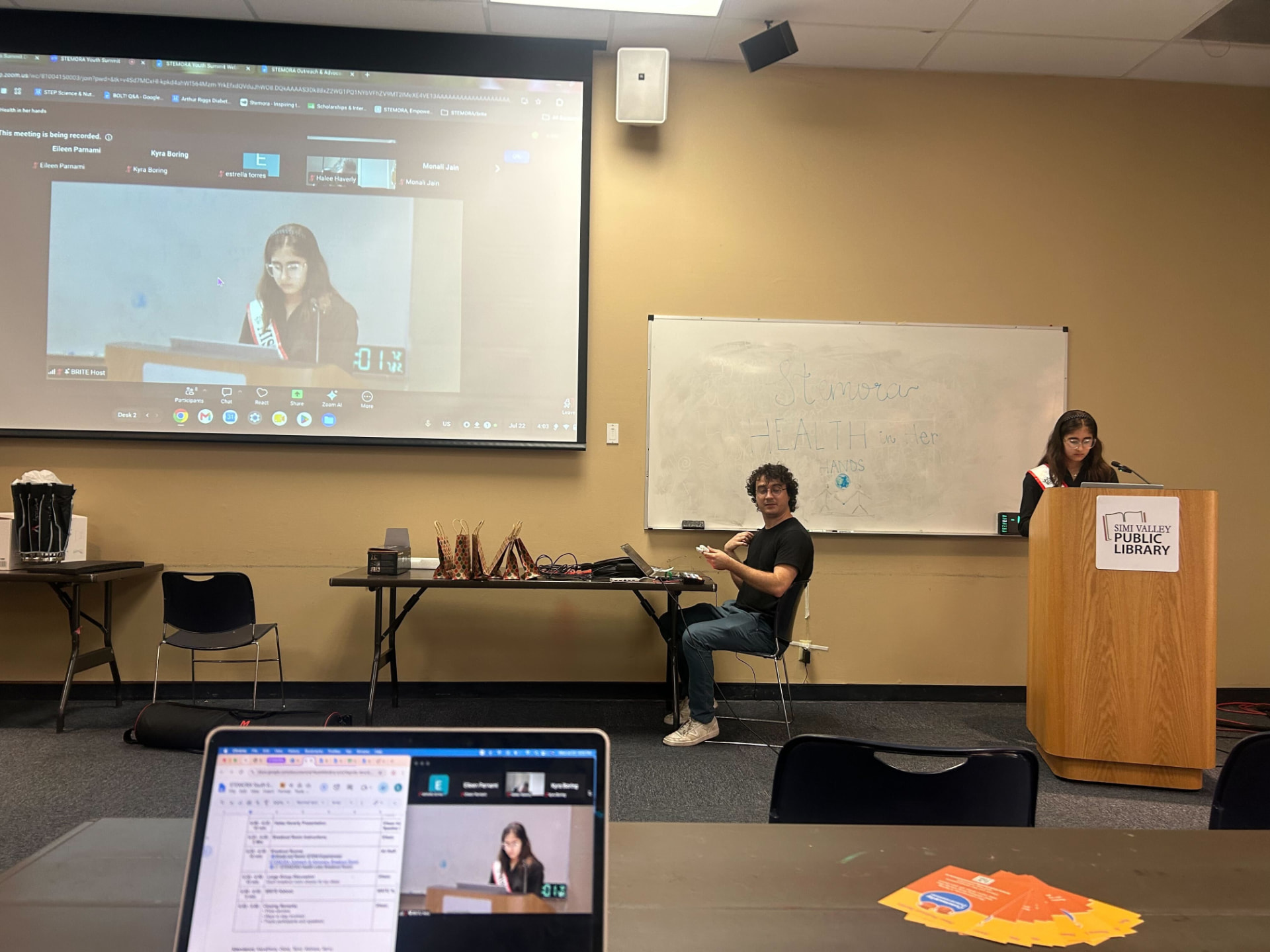 Founder Eileen Parnami presenting at the podium during the Health in Her Hands Summit